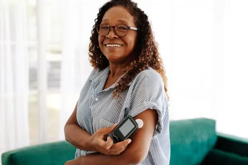 a woman checks her blood sugar with a glucose monitor