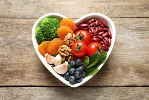 fruits and veggies in a heart shaped bowl
