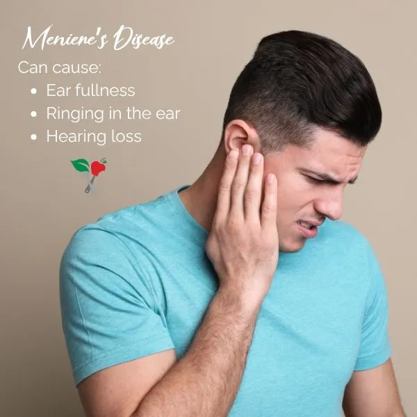 young man in pain touching his ear due to discomfort caused by menieres