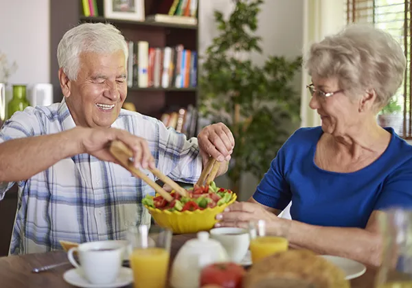 older couple eating dinner together
