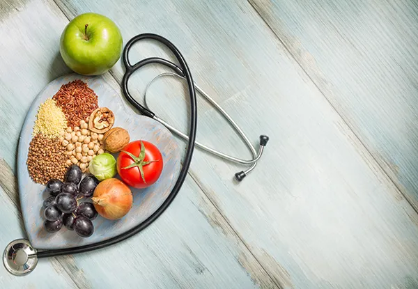 heart healthy foods and a stethoscope
