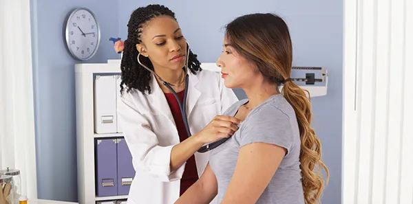 A woman getting a checkup at the doctor