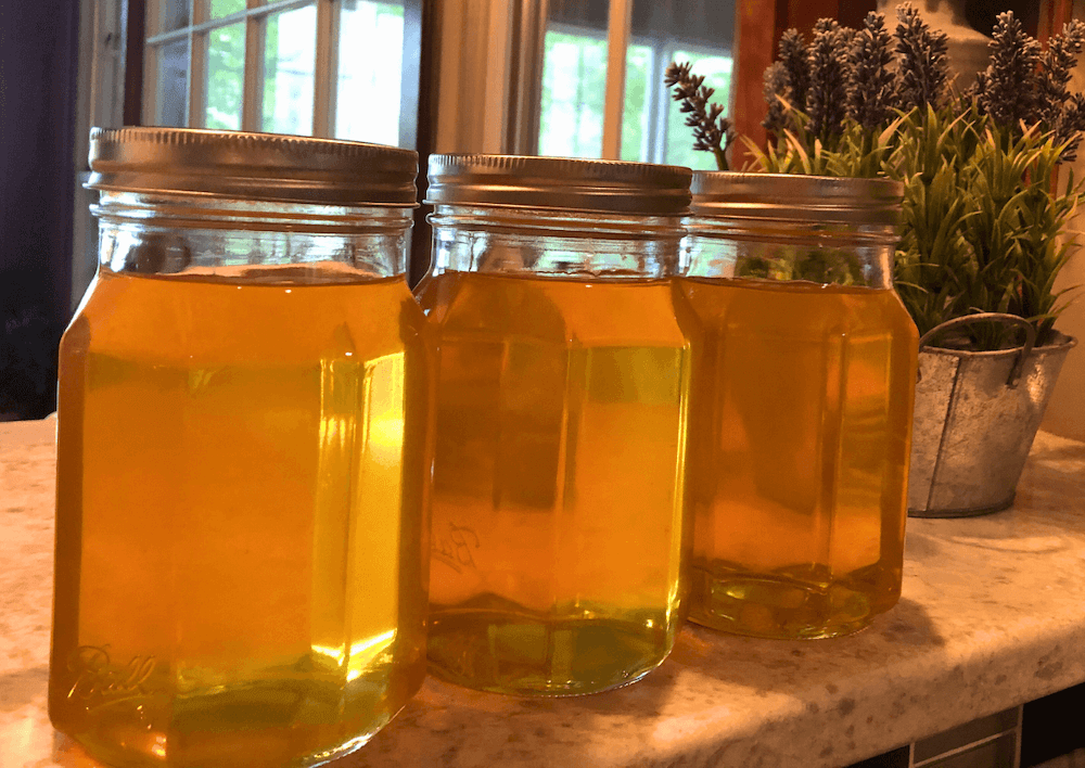 freshly poured honey in mason jars