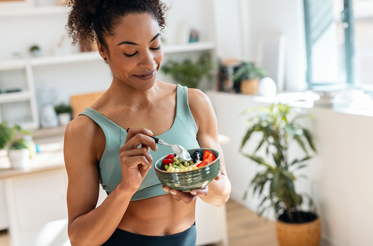 woman enjoying a healthy salad after working out