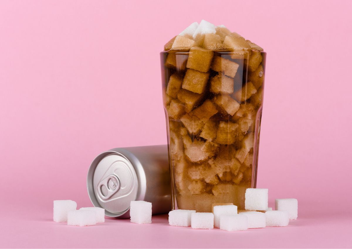 sugary drink with sugar cubes on pink background